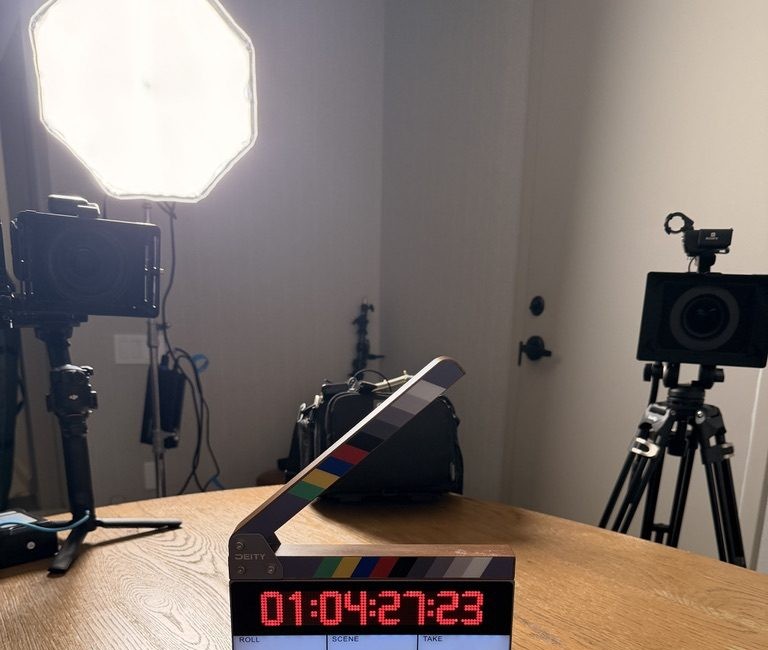 Clapperboard slate on set between a camera rig and sound bag