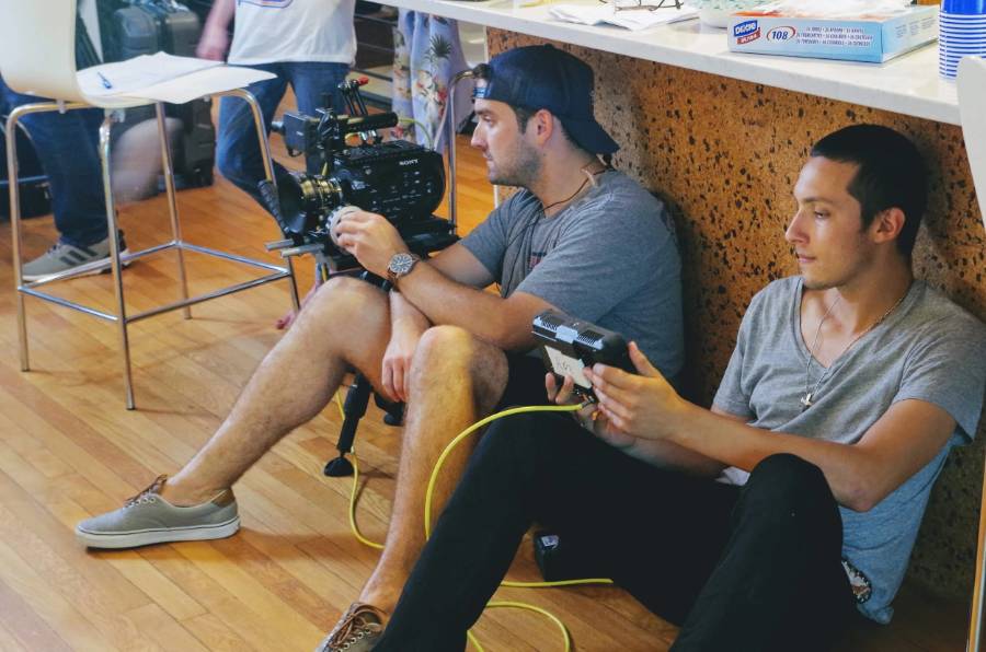 Crew reviewing a shot on a field monitor between takes
